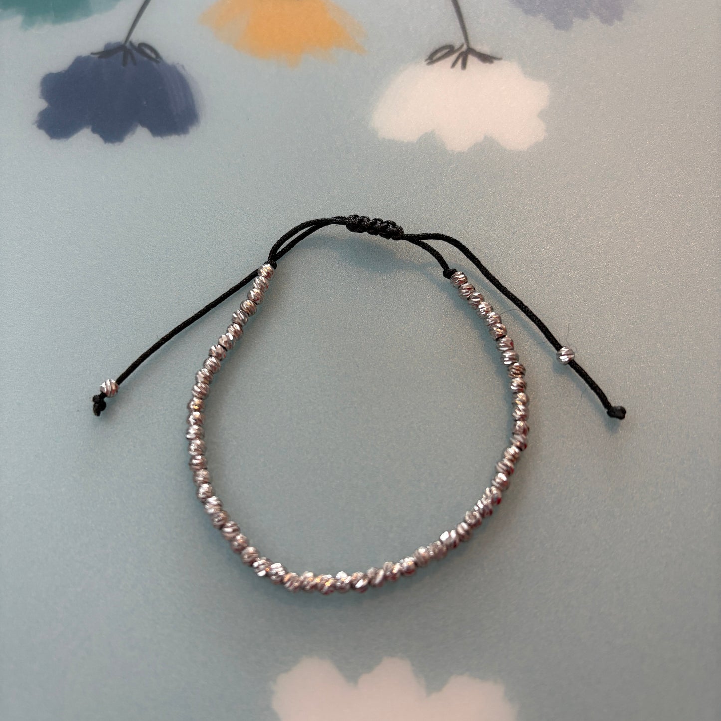 Beaded headband on a floral-patterned surface