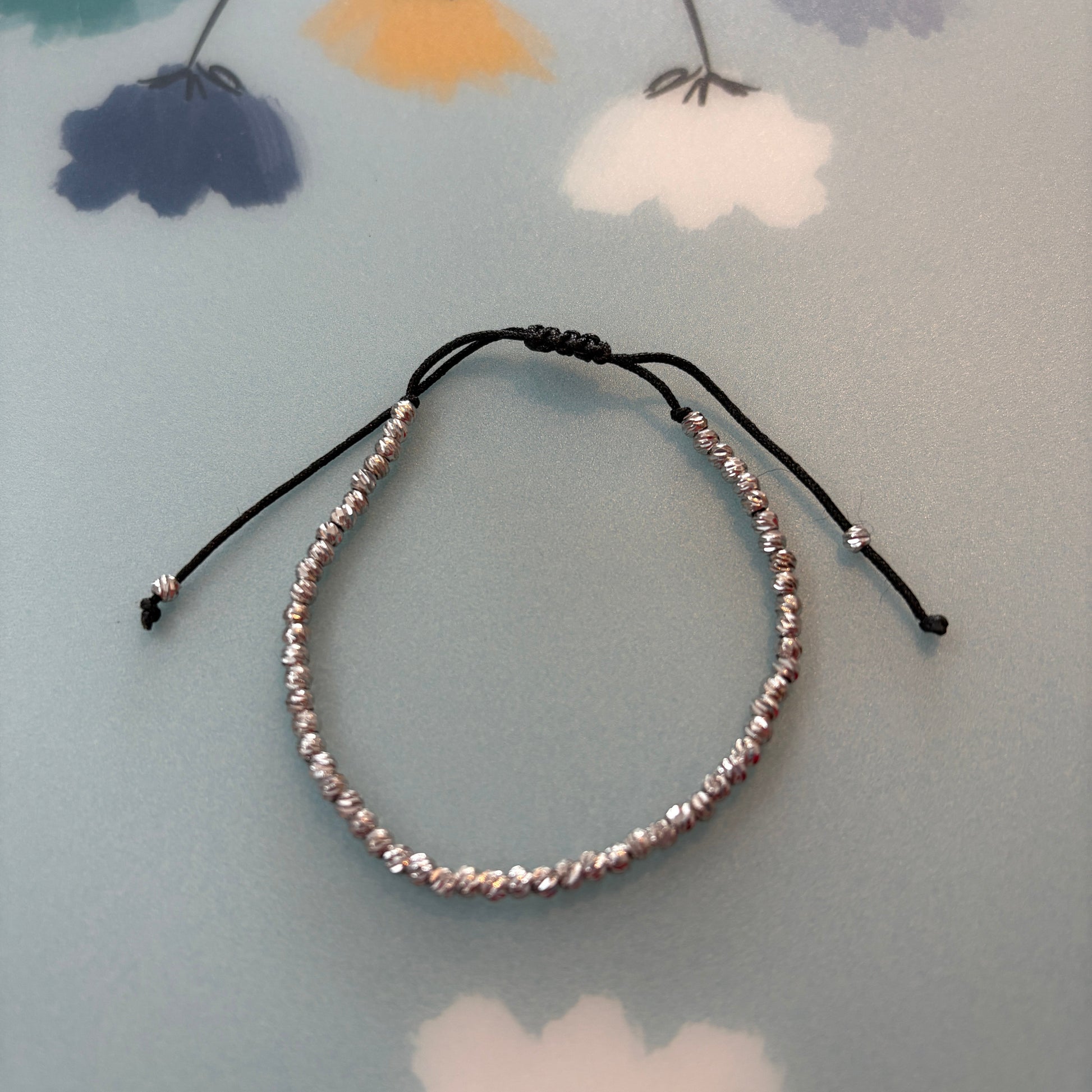 Beaded headband on a floral-patterned surface